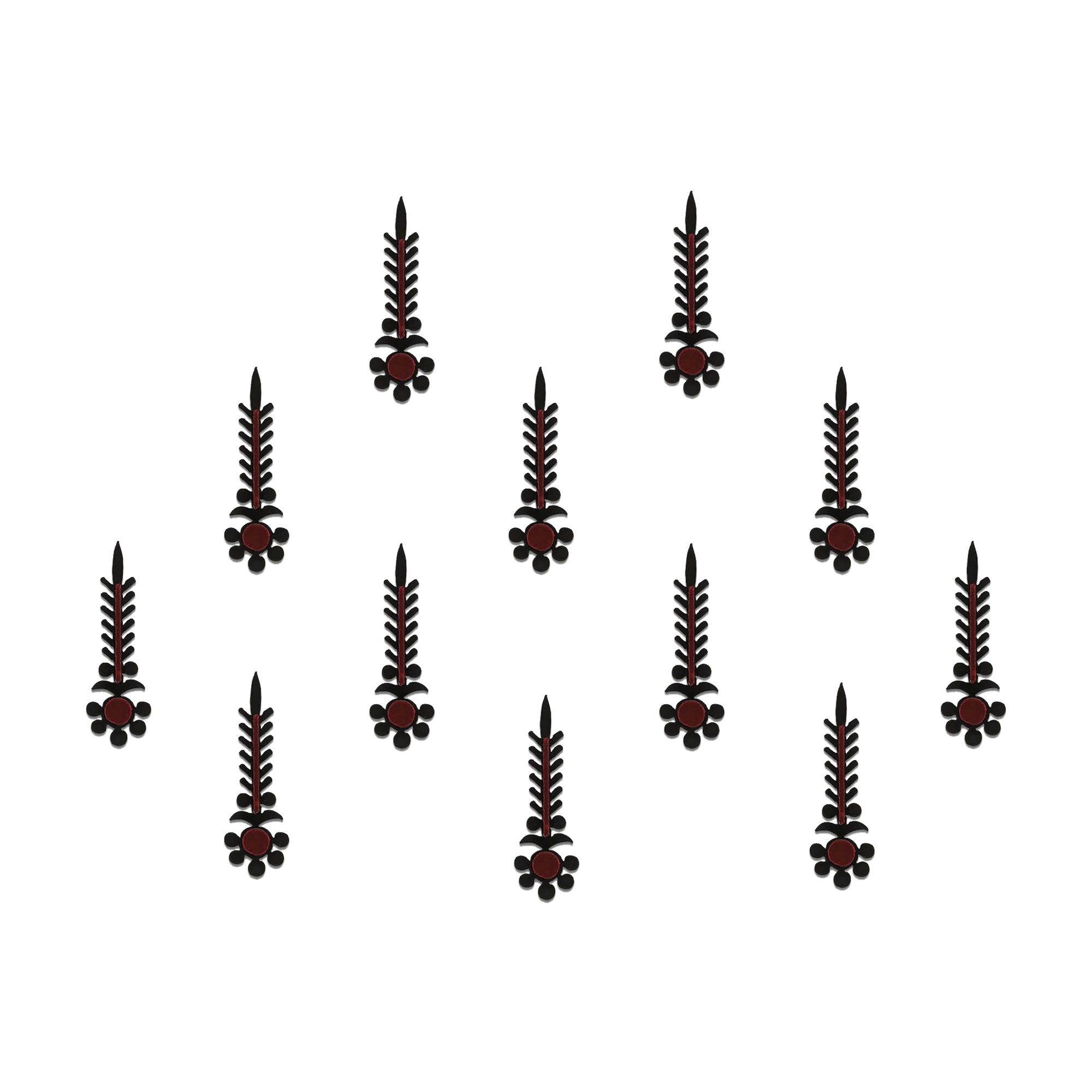 Comet Busters gothic tribal designer bindis featuring elongated black and maroon artistic motifs with abstract ethnic detailing arranged on a light background for a bold fusion-inspired traditional look.