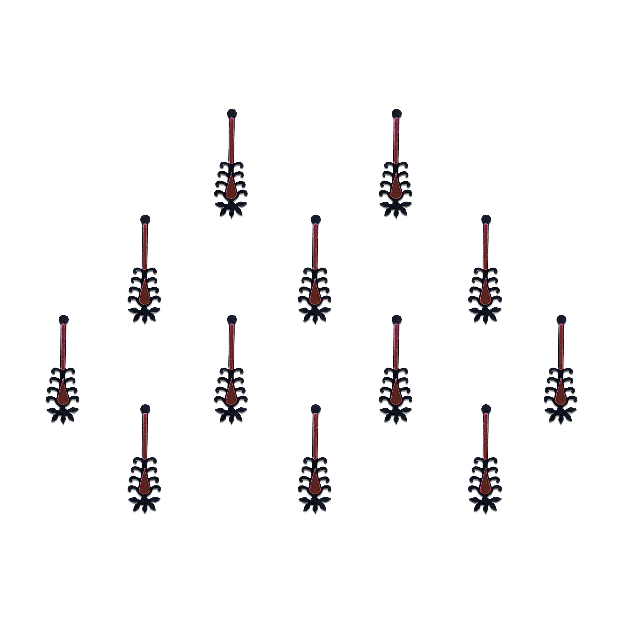 Comet Busters tribal spear designer bindis featuring elongated black and maroon ethnic motifs with geometric detailing arranged symmetrically on a light background for a bold contemporary traditional style.