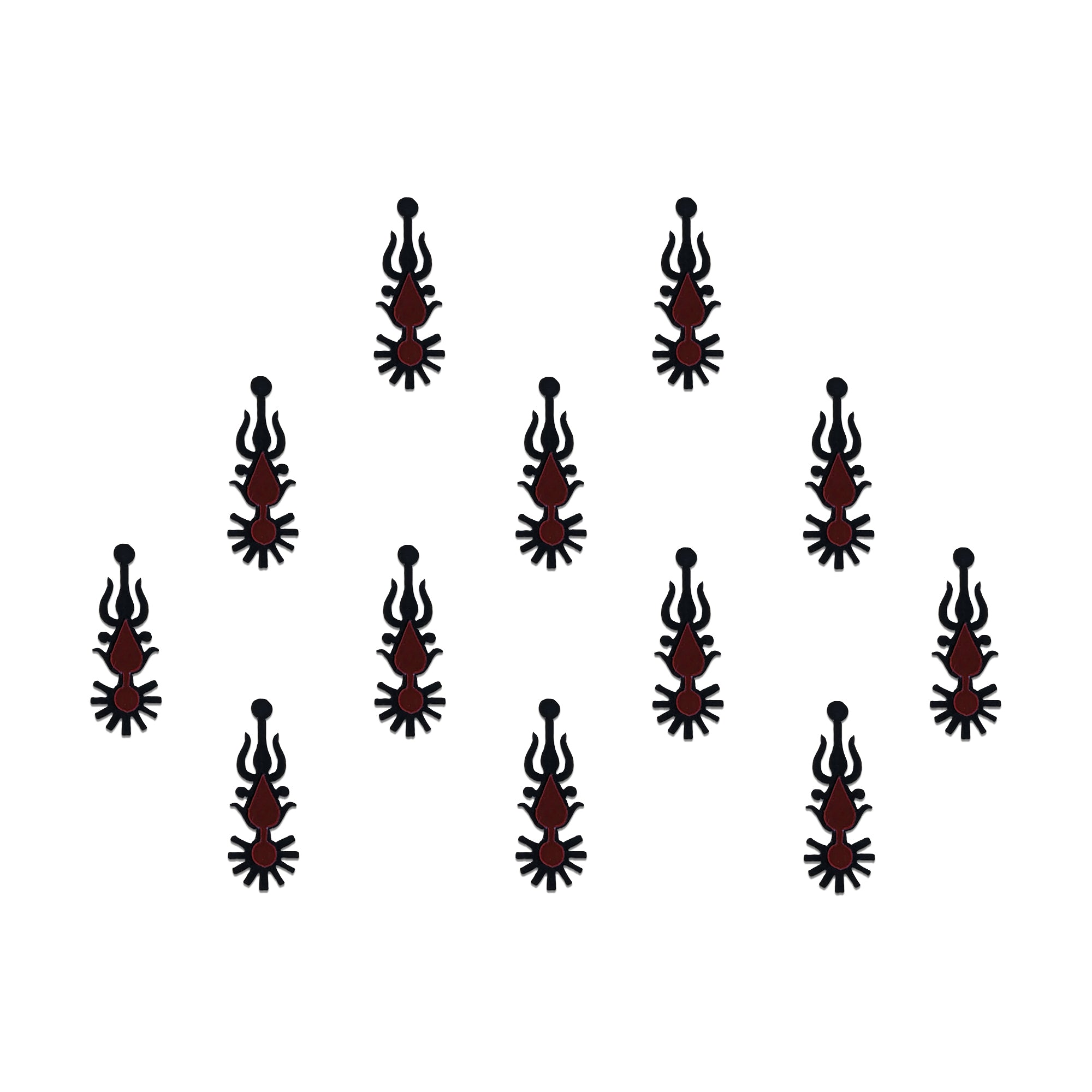 Comet Busters tribal spear designer bindis featuring elongated black and maroon ethnic motifs with geometric detailing arranged symmetrically on a light background for a bold contemporary traditional style.