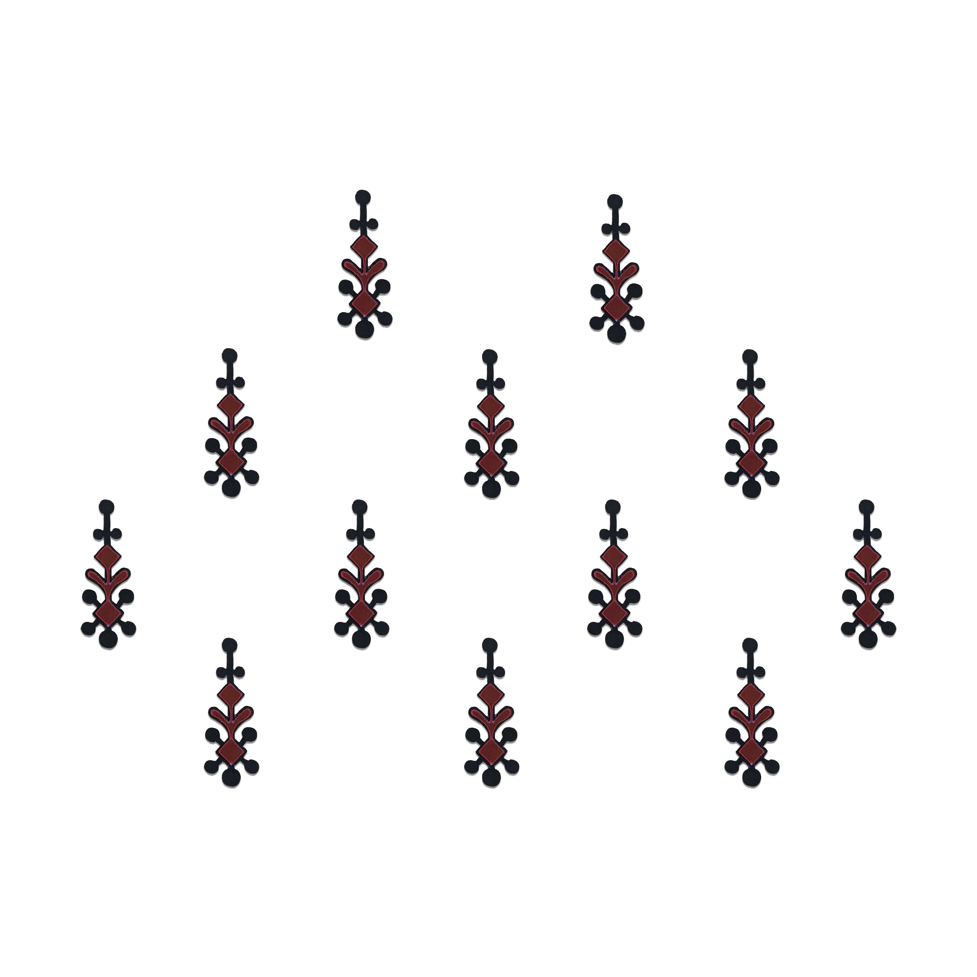 Comet Busters tribal spear designer bindis featuring elongated black and maroon ethnic motifs with geometric detailing arranged symmetrically on a light background for a bold contemporary traditional style.