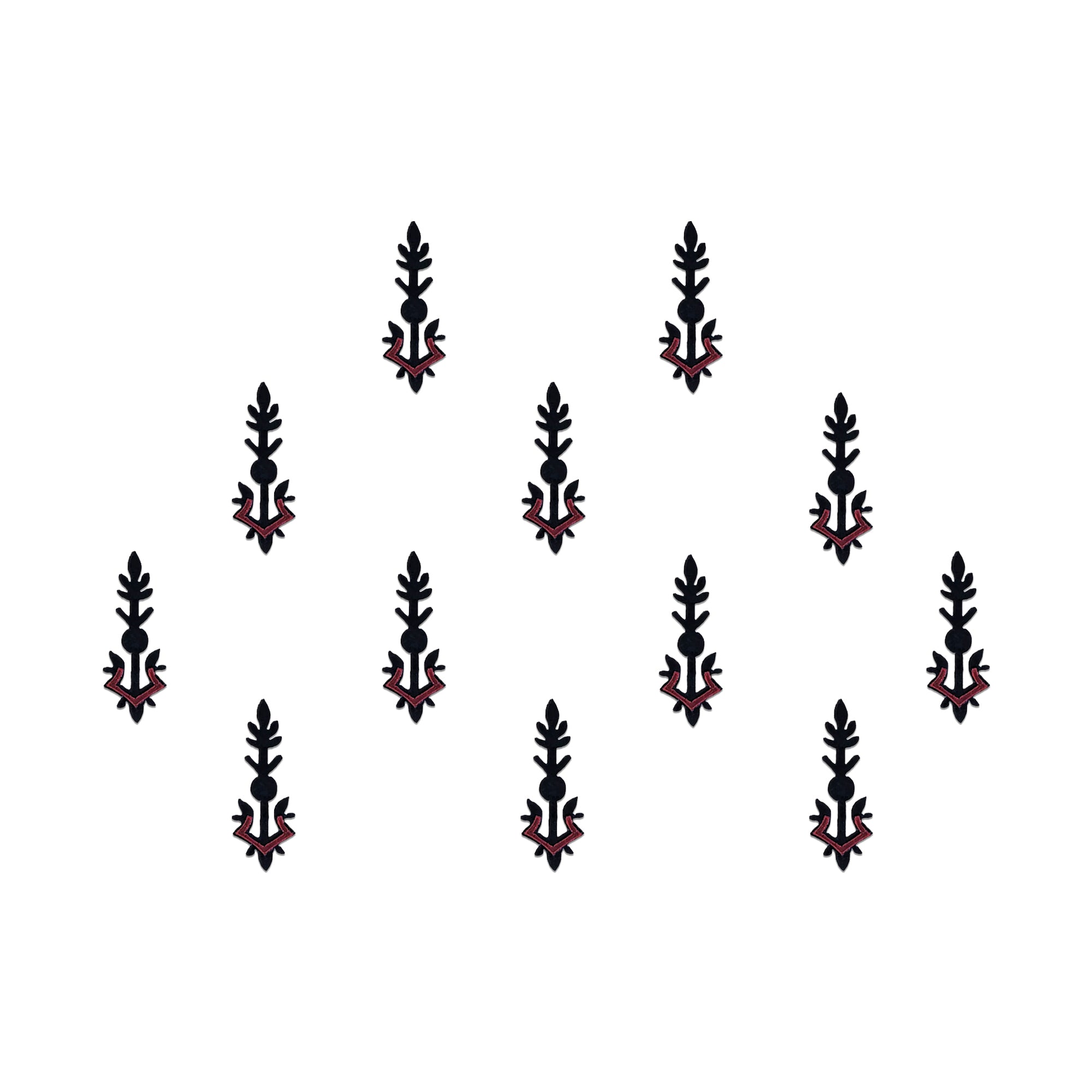 Comet Busters tribal spear designer bindis featuring elongated black and maroon ethnic motifs with geometric detailing arranged symmetrically on a light background for a bold contemporary traditional style.