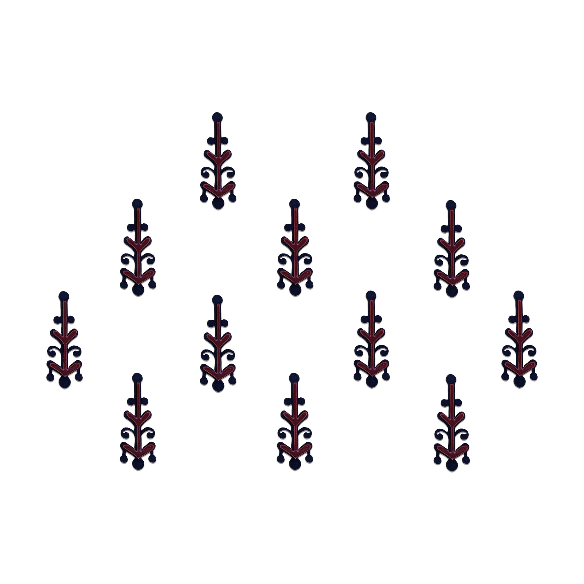 Comet Busters geometric tribal designer bindis featuring black abstract ethnic motifs with maroon diamond accents arranged in a symmetrical pattern on a light background for a bold contemporary traditional look.