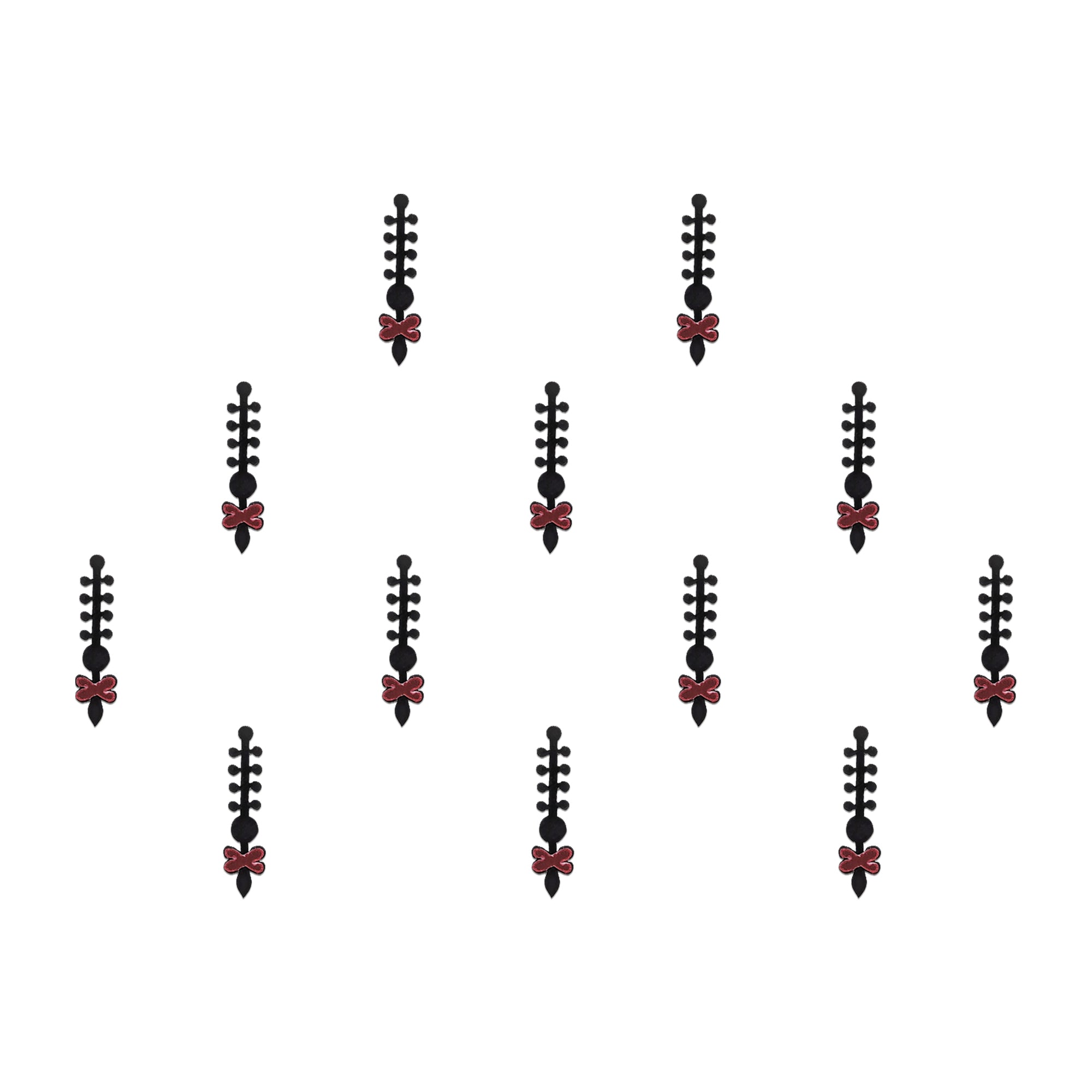 Comet Busters tribal designer bindis featuring black ethnic symbol motifs with a circular red stone center arranged on a light background, offering a bold fusion-inspired traditional look.