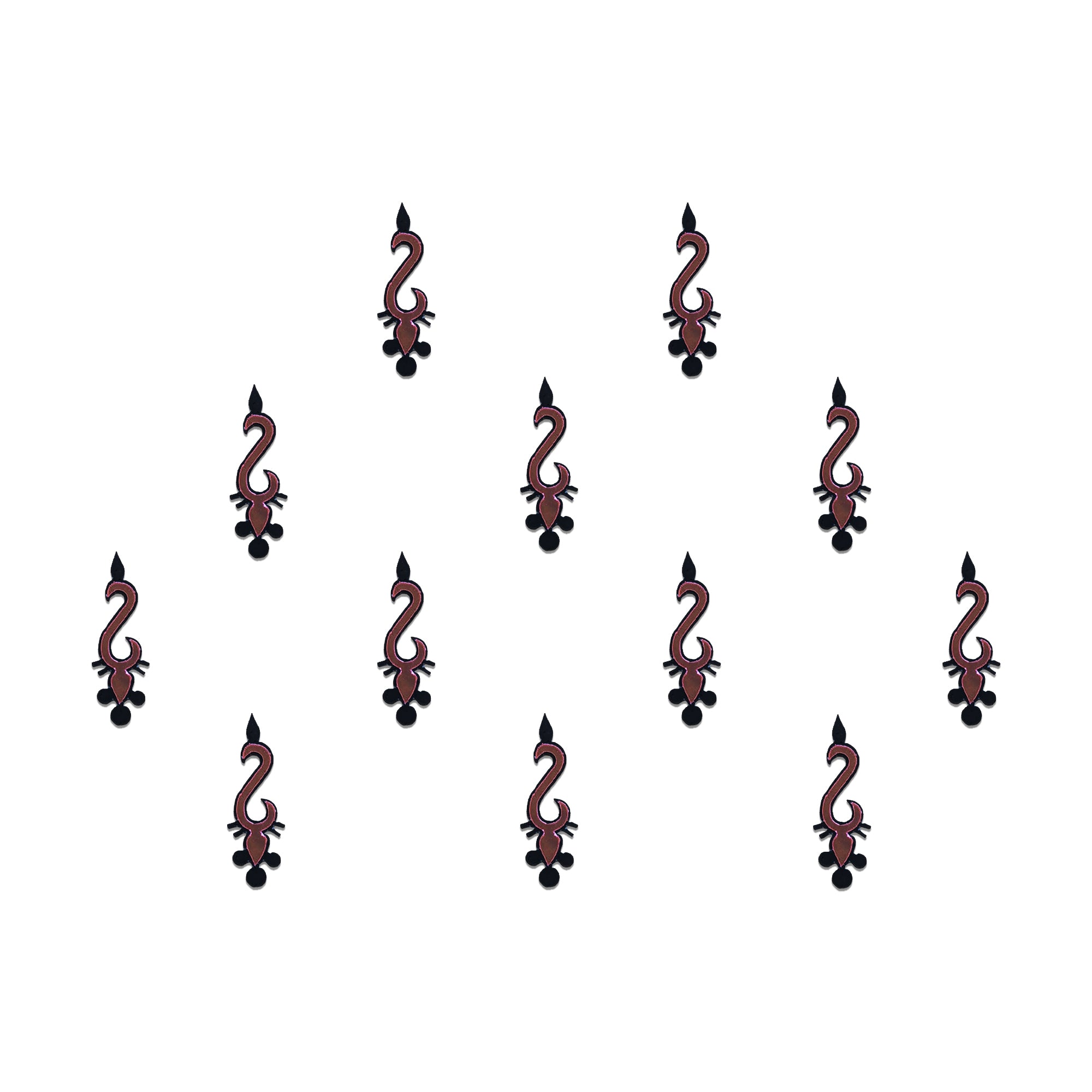 Comet Busters geometric tribal designer bindis featuring black abstract ethnic motifs with maroon diamond accents arranged in a symmetrical pattern on a light background for a bold contemporary traditional look.