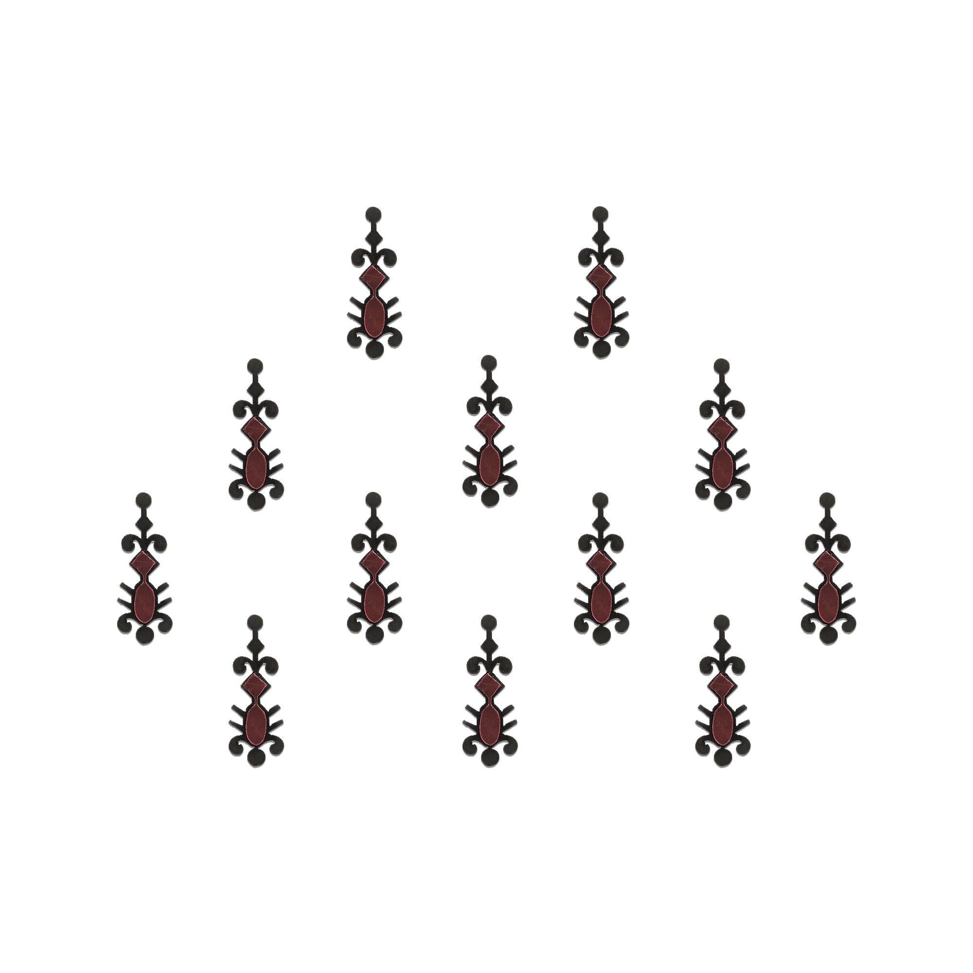 Comet Busters gothic tribal designer bindis featuring elongated black and maroon artistic motifs with abstract ethnic detailing arranged on a light background for a bold fusion-inspired traditional look.