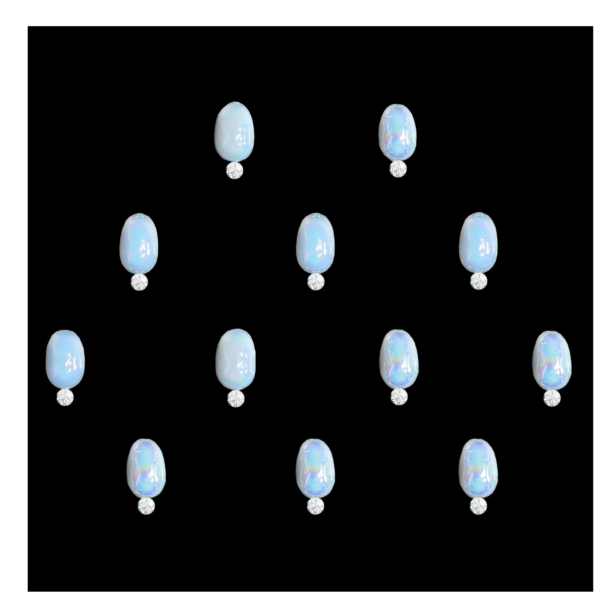 Comet Busters pearl round stone bindis featuring glossy iridescent white circular stones paired with small crystal accents on a black background, elegant self-adhesive festive bindi set for women and girls.