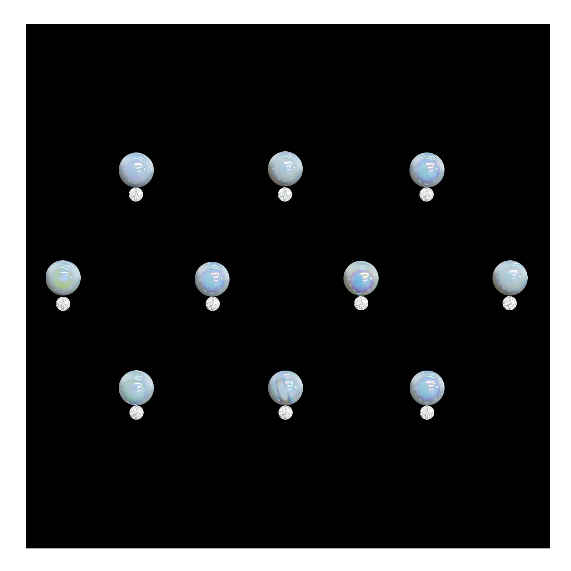 Comet Busters pearl round stone bindis featuring glossy iridescent white circular stones paired with small crystal accents on a black background, elegant self-adhesive festive bindi set for women and girls.