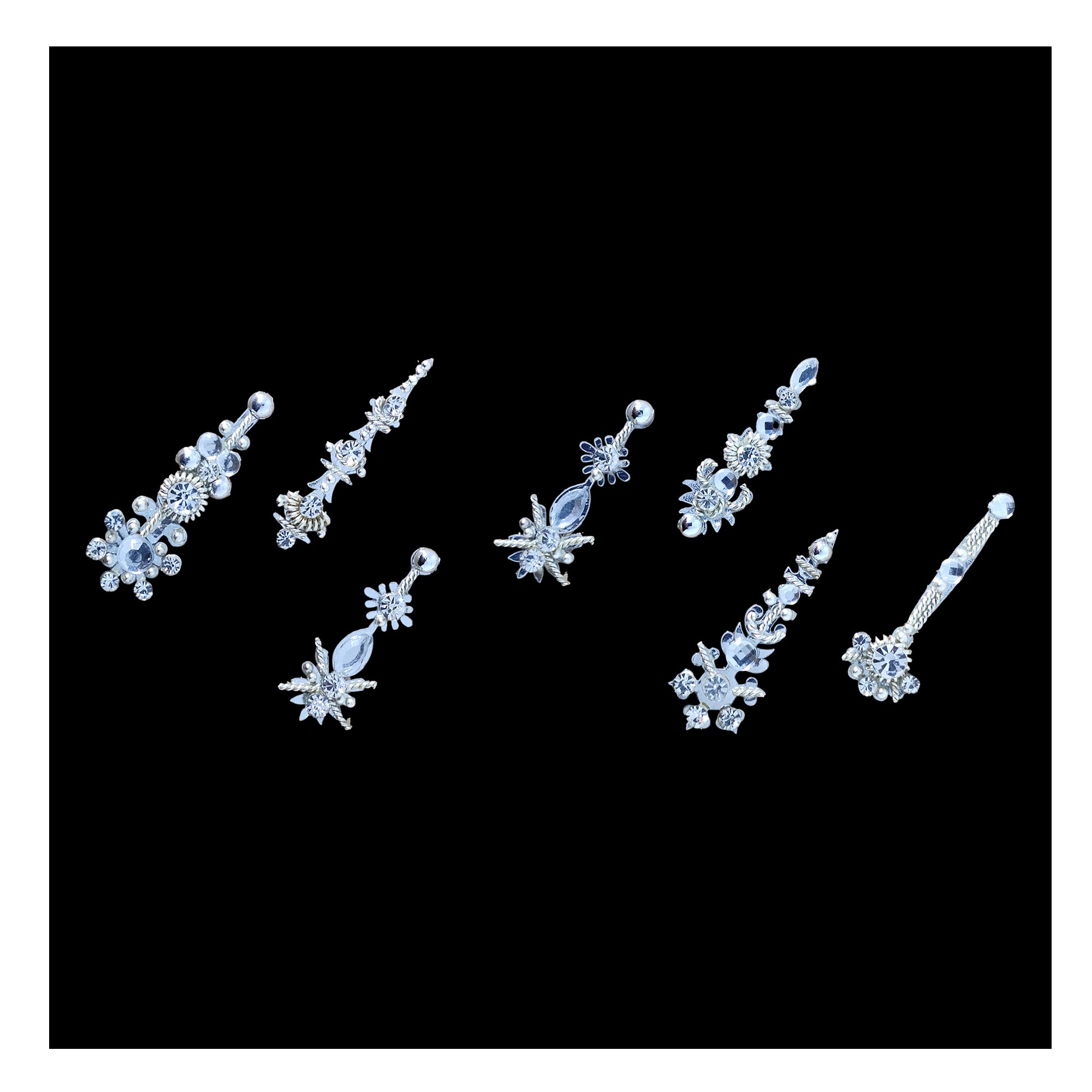Comet Busters silver designer bindi set featuring assorted floral, leaf, and elongated motifs embellished with sparkling crystal stones. Elegant self-adhesive reusable bindis for women and girls, perfect for weddings, parties, festive occasions, bridal wear, sarees, lehengas, kurtis, and other traditional or ethnic outfits.