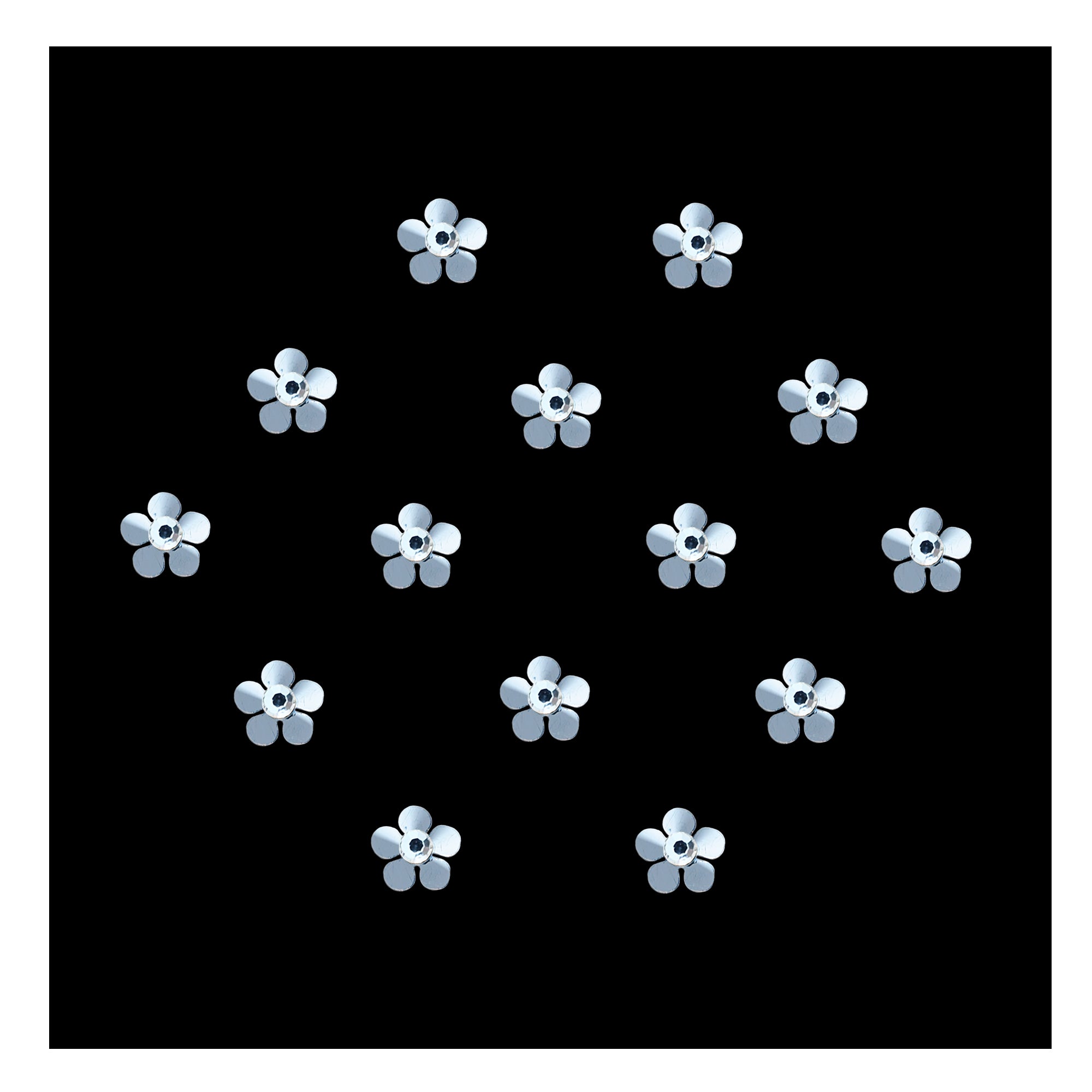 Silver floral designer bindi with petal-shaped detailing and sparkling crystal stone center, elegant stick-on forehead accessory for festive and ethnic wear.