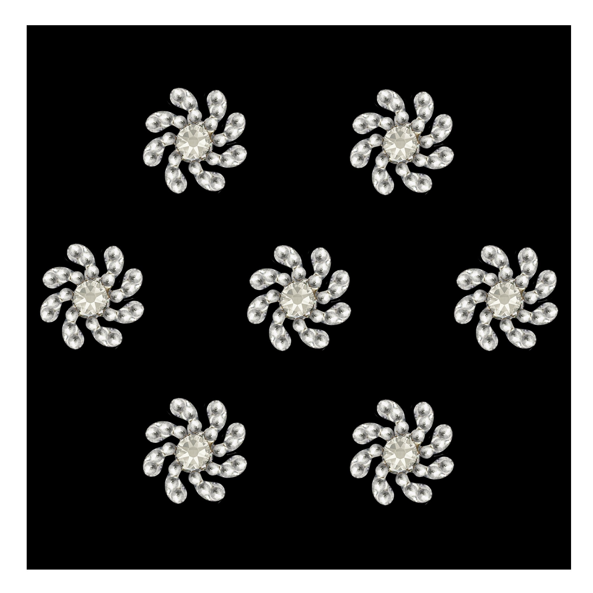 Comet Busters premium silver swirl designer bindis featuring a sparkling central crystal stone surrounded by curved petal-like crystal detailing in an elegant spiral floral pattern for festive and party wear styling.