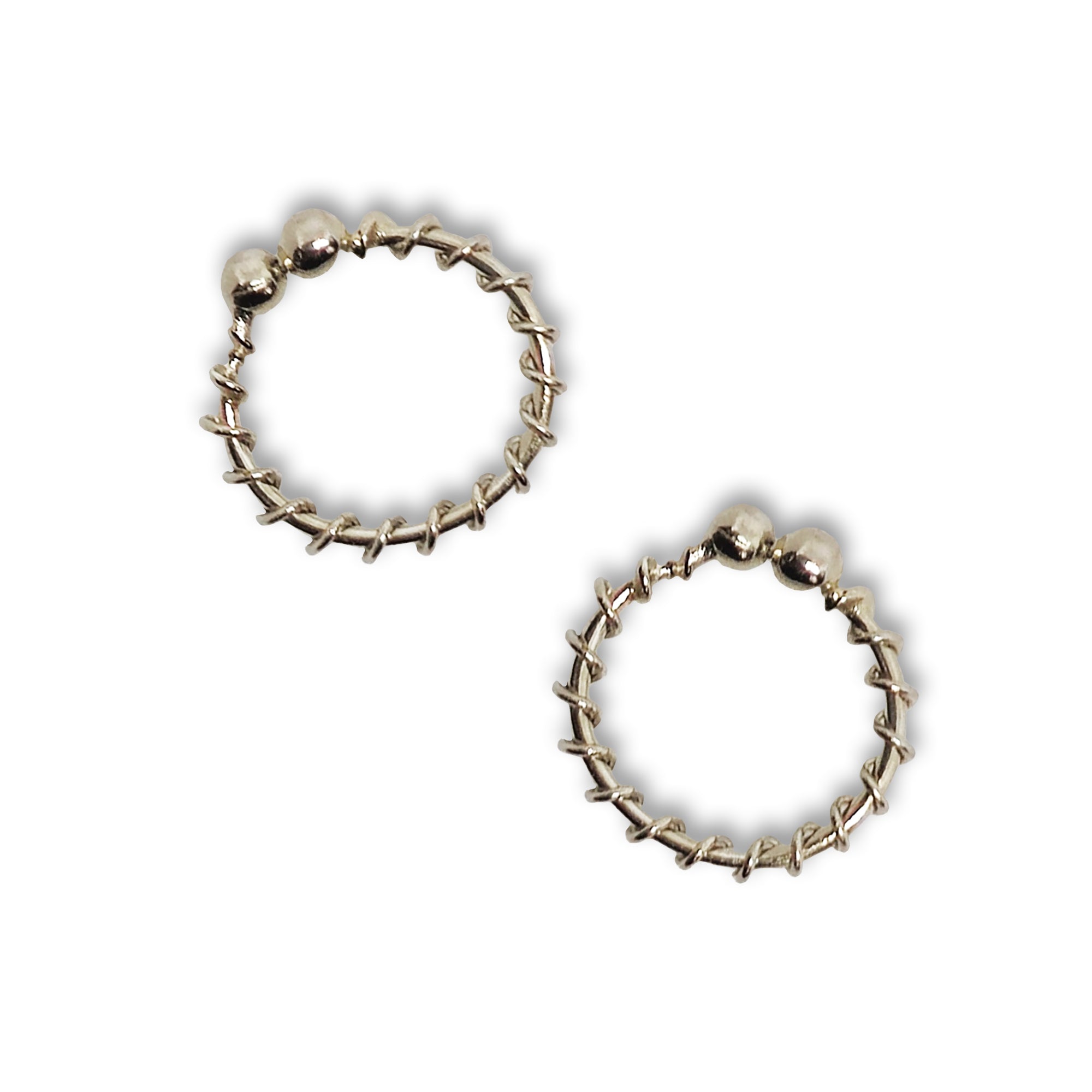 Comet Busters silver twisted hoop stick-on nose ring featuring a textured spiral-style circular design with rounded bead detailing for a stylish traditional look.